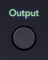 Cutout of the 18i20's Output button in its on state (green).
